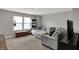 Neutral living room boasts a comfortable sectional sofa, plush carpeting, and natural light from two windows at 8583 Strabet Dr, Pendleton, IN 46064
