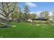 The backyard is spacious with a well-maintained lawn, storage sheds, and a fire pit at 9034 Caminito Ct, Indianapolis, IN 46234