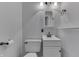 Modern bathroom with a white toilet, vanity with storage, and black hardware at 9034 Caminito Ct, Indianapolis, IN 46234
