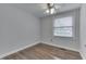 Cozy bedroom featuring hardwood floors, a ceiling fan, and a window for natural light at 9034 Caminito Ct, Indianapolis, IN 46234