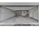 Spacious two-car garage offering ample storage and parking with a concrete floor and white walls at 9034 Caminito Ct, Indianapolis, IN 46234