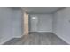 Neutral living room features modern gray plank flooring with a white painted door and white painted trim at 9034 Caminito Ct, Indianapolis, IN 46234