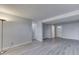 Open-concept living room featuring neutral gray walls and modern plank flooring with multiple entryways and lighting at 9034 Caminito Ct, Indianapolis, IN 46234