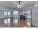 Open-concept living room flows into the kitchen with hardwood floors and a stylish light fixture at 9034 Caminito Ct, Indianapolis, IN 46234