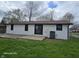 View of the backyard featuring a concrete patio with sliding glass doors and an AC unit at 909 Pearl St, Cicero, IN 46034