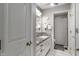 Clean bathroom with a granite countertop, white cabinets, and a shower with patterned tile at 9658 Highgate N Cir, Indianapolis, IN 46250