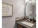 Tastefully decorated powder room featuring modern fixtures, stylish mirror, and elegant vanity at 9658 Highgate N Cir, Indianapolis, IN 46250