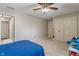 Bright bedroom with ceiling fan, carpet flooring, double door closet, and access to bathroom at 9658 Highgate N Cir, Indianapolis, IN 46250