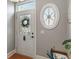 Bright foyer featuring a stylish front door with glass window and elegant oval window accent at 9658 Highgate N Cir, Indianapolis, IN 46250