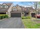 Well-maintained townhome with a two-car garage, inviting front yard, and charming curb appeal at 9658 Highgate N Cir, Indianapolis, IN 46250