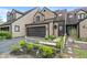 Attractive townhome featuring a spacious driveway, attached garage, and well-maintained front garden at 9658 Highgate N Cir, Indianapolis, IN 46250