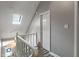 Bright hallway with a skylight and white railing leading to the lower level at 9658 Highgate N Cir, Indianapolis, IN 46250