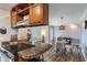 Kitchen with breakfast bar leading to a dining area with a glass table and seating at 9658 Highgate N Cir, Indianapolis, IN 46250