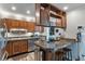 Kitchen boasts stainless steel appliances, granite countertops, wood cabinets, and a breakfast bar with seating at 9658 Highgate N Cir, Indianapolis, IN 46250