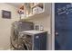 Laundry room featuring a modern washer and dryer set with overhead shelving for storage at 9658 Highgate N Cir, Indianapolis, IN 46250