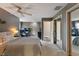 Spacious bedroom with a ceiling fan, large closet, and neutral decor at 9658 Highgate N Cir, Indianapolis, IN 46250