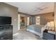 Inviting bedroom with a TV, dresser, ceiling fan, and access to the en-suite bathroom and closet at 9658 Highgate N Cir, Indianapolis, IN 46250