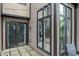 Cozy outdoor patio features seating, sliding glass doors, and exterior lighting for entertaining at 9658 Highgate N Cir, Indianapolis, IN 46250
