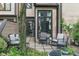 This cozy outdoor patio offers shaded seating with large windows looking into the home at 9658 Highgate N Cir, Indianapolis, IN 46250
