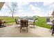 Backyard patio area with furniture, grill, and above ground pool in a serene and expansive backyard setting at 10239 Wilson Rd, Brownsburg, IN 46112