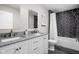 Beautiful bathroom featuring double vanity with granite countertops and shower with striking black hexagon tile at 10239 Wilson Rd, Brownsburg, IN 46112