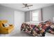 Comfortable bedroom featuring floral bedding, ceiling fan and natural lighting at 10239 Wilson Rd, Brownsburg, IN 46112
