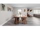 Bright dining room featuring a large wooden table, wood floors, and multiple windows for natural light at 10239 Wilson Rd, Brownsburg, IN 46112