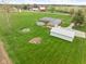 Aerial view of a brick home featuring a large lawn, barn, garage, and a pool on a spacious lot at 10239 Wilson Rd, Brownsburg, IN 46112