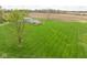 Aerial view of a well-maintained home with a large green lawn and views of the neighboring farmland at 10239 Wilson Rd, Brownsburg, IN 46112