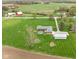 Aerial view of a ranch home with a large lawn, pool, barn, and garage on a spacious lot at 10239 Wilson Rd, Brownsburg, IN 46112