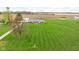 Wide shot of home with massive green lawn and mowed stripes at 10239 Wilson Rd, Brownsburg, IN 46112