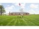 Well maintained brick home with manicured lawn and American flag at 10239 Wilson Rd, Brownsburg, IN 46112