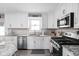 Well-equipped kitchen featuring stainless steel appliances, granite countertops, and ample white cabinetry at 10239 Wilson Rd, Brownsburg, IN 46112