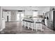 Modern kitchen with stainless steel appliances, a center island with seating, and white cabinets at 10239 Wilson Rd, Brownsburg, IN 46112