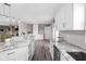 Open kitchen design with stainless appliances, granite countertops, and white cabinets with long site to living room at 10239 Wilson Rd, Brownsburg, IN 46112