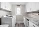 Convenient laundry room with washer, dryer, granite counters, and ample storage at 10239 Wilson Rd, Brownsburg, IN 46112