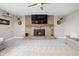 Spacious living room with brick fireplace and mounted television, creating a cozy and inviting atmosphere at 10239 Wilson Rd, Brownsburg, IN 46112