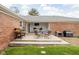 Outdoor patio area includes a table and chairs, barbecue grill, and red brick exterior of home at 10239 Wilson Rd, Brownsburg, IN 46112