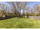 Expansive backyard featuring lush green grass, mature trees, and a privacy fence, ideal for outdoor activities at 10586 W School Pkwy, Carmel, IN 46280