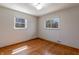 Bedroom with hardwood floors, neutral walls and two windows providing natural light at 10586 W School Pkwy, Carmel, IN 46280