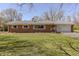 Charming brick home with an attached garage and a well-manicured lawn at 10586 W School Pkwy, Carmel, IN 46280