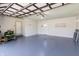 A spacious garage with a freshly painted floor, two doors, and ample storage for vehicles and equipment at 10586 W School Pkwy, Carmel, IN 46280
