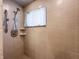 Tiled shower featuring an adjustable shower head, built-in shelves and a window at 10586 W School Pkwy, Carmel, IN 46280