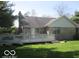 Backyard deck on brick house surrounded by well-maintained lawn and mature trees at 1080 W Wildflower Ct, Mooresville, IN 46158