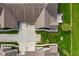 An aerial view shows the property's layout, landscaping, and concrete driveways at 1098 Extraordinary Trl, Greenfield, IN 46140