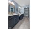 Well-lit bathroom with a double vanity, neutral countertops, and a walk-in closet at 1098 Extraordinary Trl, Greenfield, IN 46140