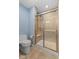 Updated bathroom features a tiled shower with glass door and matching ceramic tile surround at 1098 Extraordinary Trl, Greenfield, IN 46140
