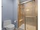Updated bathroom features a tiled shower with glass door and matching ceramic tile surround at 1098 Extraordinary Trl, Greenfield, IN 46140