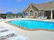 A community pool with lounge chairs and umbrellas provides residents a place to relax at 1098 Extraordinary Trl, Greenfield, IN 46140