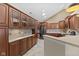 Bright kitchen showcasing wood cabinets, ample counter space, and modern stainless steel appliances at 1098 Extraordinary Trl, Greenfield, IN 46140